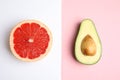 Cut ripe avocado and grapefruit on color background Royalty Free Stock Photo