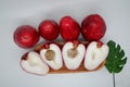 Cut ripe Malay apple or plum rose served on wooden plate with four plum roses behind Royalty Free Stock Photo