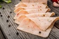 Cut sausage from ham on a wooden background