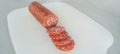 Cut sausage and knife on white background Royalty Free Stock Photo