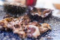 Cut sea urchins laid in the shell on a dish with lemon