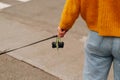 Cut shot of a woman holding dog leash with nice poop bags holder while walking.