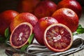 Cut Sicilian bloody oranges on a gray cloth and a knife on an ol Royalty Free Stock Photo