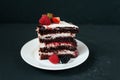 Cut slice of cream cake. On black background and a white saucer, with strawberry raspberries. Dietary white from cream Royalty Free Stock Photo