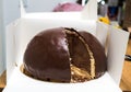 Cut slice of Delicious Bombe au chocolat translated chocolate bomb on the wooden