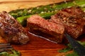 Cut slices of grilled beefsteak on board close up