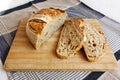 Cut slices of sourdough bread loaf on a wooden board Royalty Free Stock Photo