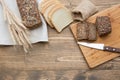 Fitness bread. A loaf of fresh rustic whole meal rye bread, sliced on a wooden board, rural food background. Top view. Copy space. Royalty Free Stock Photo