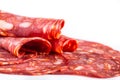 Cut Spanish sausage or salami chorizo. Isolated on white Royalty Free Stock Photo