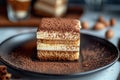 A cut square of tiramisu with defined layers of cream and cake on a black plate. Generative AI Royalty Free Stock Photo