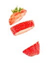 Strawberry in three pieces in the air. sliced strawberry floating on air isolated on white background Royalty Free Stock Photo