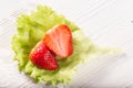 The cut strawberry berry on a green lettuce leaf Royalty Free Stock Photo