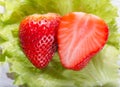 The cut strawberry berry on a green lettuce leaf Royalty Free Stock Photo