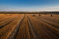 top view on field with stubble lines and straw rolls