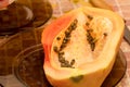 Cut into two parts papaya fruit with seeds