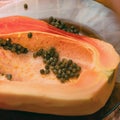 Cut into two parts papaya fruit with seeds