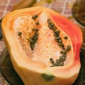 Cut into two parts papaya fruit with seeds