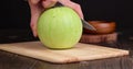 Cut an unripe small watermelon on the table