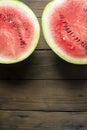 A cut watermelon. Watermelon on a wooden table.. A large watermelon is cut into two halves. Royalty Free Stock Photo