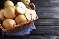 Cut and whole apple pears in basket on black wooden table. Space for text Royalty Free Stock Photo