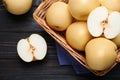 Cut and whole apple pears on black wooden table, flat lay Royalty Free Stock Photo