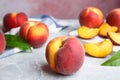 Cut and whole juicy peaches and leaves on table Royalty Free Stock Photo