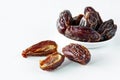 Cut and whole medjool dates against a white background. Royalty Free Stock Photo