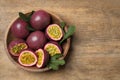 Cut and whole passion fruits maracuyas on wooden table, top view. Space for text Royalty Free Stock Photo