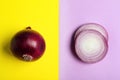 Cut and whole red onions on color background Royalty Free Stock Photo