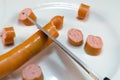 Cut Wiener sausage with scissors