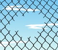 Cut wire fence with blue sky background Royalty Free Stock Photo