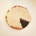 Cutaway cheesecake with cutaway on a black plate, isolated on belm background.