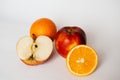 Cutaway orange and apple on a white background