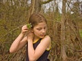 Cute 8 Year Old Girl Putting Flowers in Hair