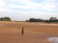 Cute Aboriginal child running all excited towards the water at Rapid Creek. Darwin NT Australia. Royalty Free Stock Photo