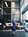 Cute adorable abandoned sad lonely preschool Caucasian little girl child standing alone in mall shop between sliding doors waiting Royalty Free Stock Photo