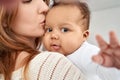 Cute adorable african american infant baby daughter having fun in moms arms. Royalty Free Stock Photo