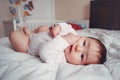 Cute adorable Asian mixed race baby girl four months old lying on bed Royalty Free Stock Photo