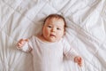 Cute adorable Asian mixed race baby girl four months old lying on bed Royalty Free Stock Photo