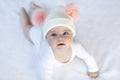 Cute adorable baby child with warm white and pink hat with cute bobbles Royalty Free Stock Photo