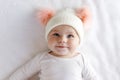 Cute adorable baby child with warm white and pink hat with cute bobbles Royalty Free Stock Photo