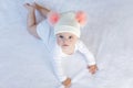 Cute adorable baby child with warm white and pink hat with cute bobbles Royalty Free Stock Photo