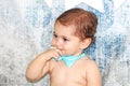 Cute adorable baby with a finger in his mouth Royalty Free Stock Photo