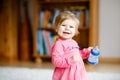 Cute adorable baby girl holding nursing bottle and drinking formula milk or water. First food for babies. Healthy babies Royalty Free Stock Photo