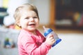 Cute adorable baby girl holding nursing bottle and drinking formula milk or water. First food for babies. Healthy babies Royalty Free Stock Photo