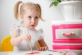 Cute adorable baby girl learning painting with water colors. Little toddler child drawing at home, using colorful brushes. Healthy Royalty Free Stock Photo