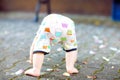 Cute adorable baby girl making first steps outdoors. Healthy happy toddler child learning walking. Lovely girl enjoying Royalty Free Stock Photo