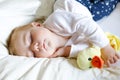 Cute adorable baby girl of 6 months sleeping peaceful in bed Royalty Free Stock Photo