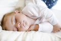 Cute adorable baby girl of 6 months sleeping peaceful in bed Royalty Free Stock Photo