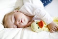 Cute adorable baby girl of 6 months sleeping peaceful in bed Royalty Free Stock Photo